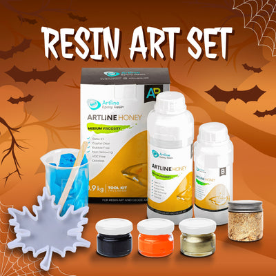 Artline Halloween Resin Craft Kit with epoxy resin, gold, black, and orange pigments, mixing tools, and silicone mold for Halloween decorations