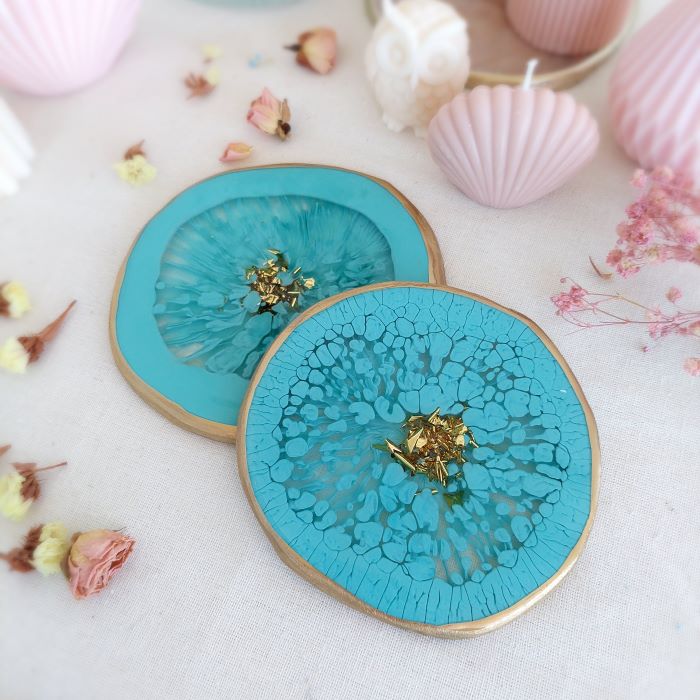 Turquoise blue pigment paste design on coasters, perfect for tinting epoxy resins.