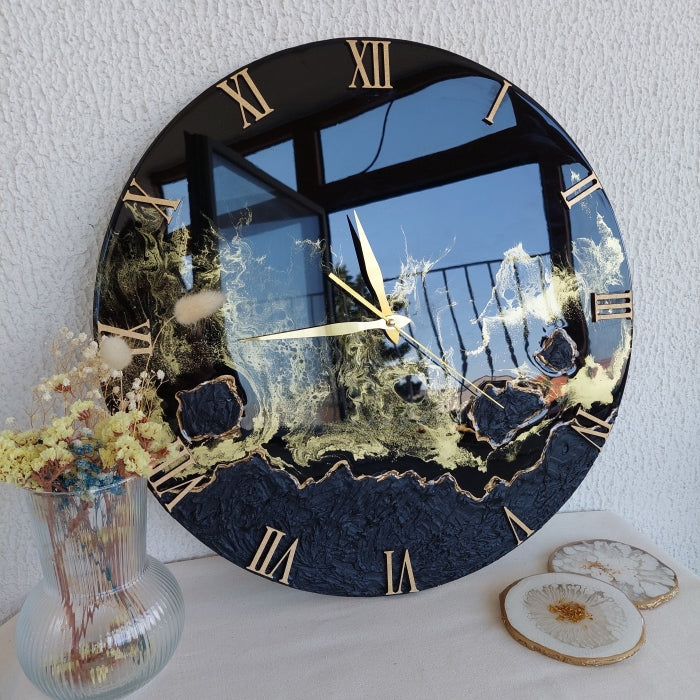 Decorative wall clock with black and gold pigment design using pigment paste.