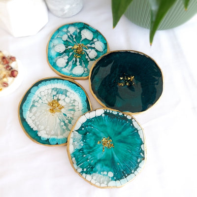 Pigment paste light green resin art coasters with teal, white, and gold accents.