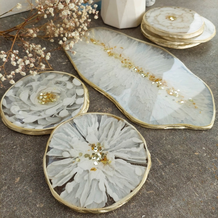 Decorative resin coasters and tray featuring white pigment paste design with gold accents.