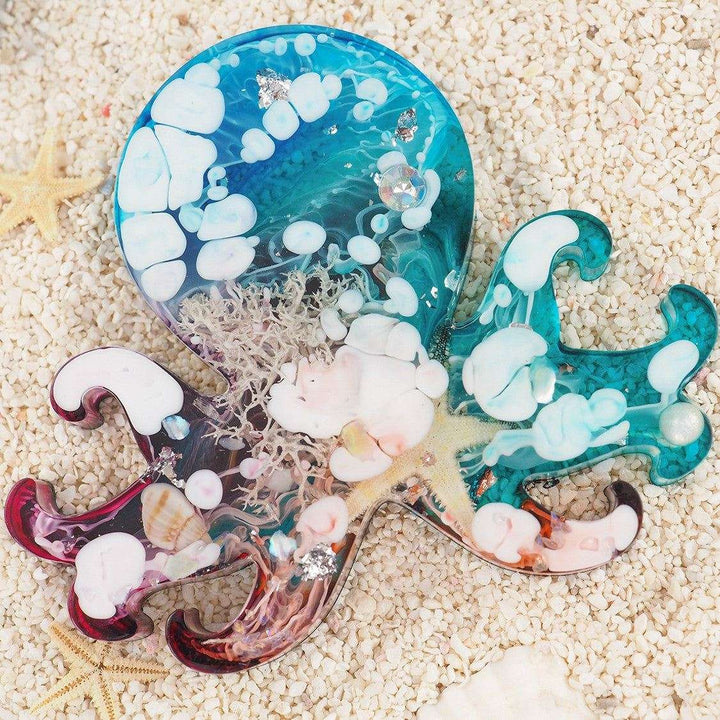 Silicone mold creating ocean animal resin decoration on sandy background.